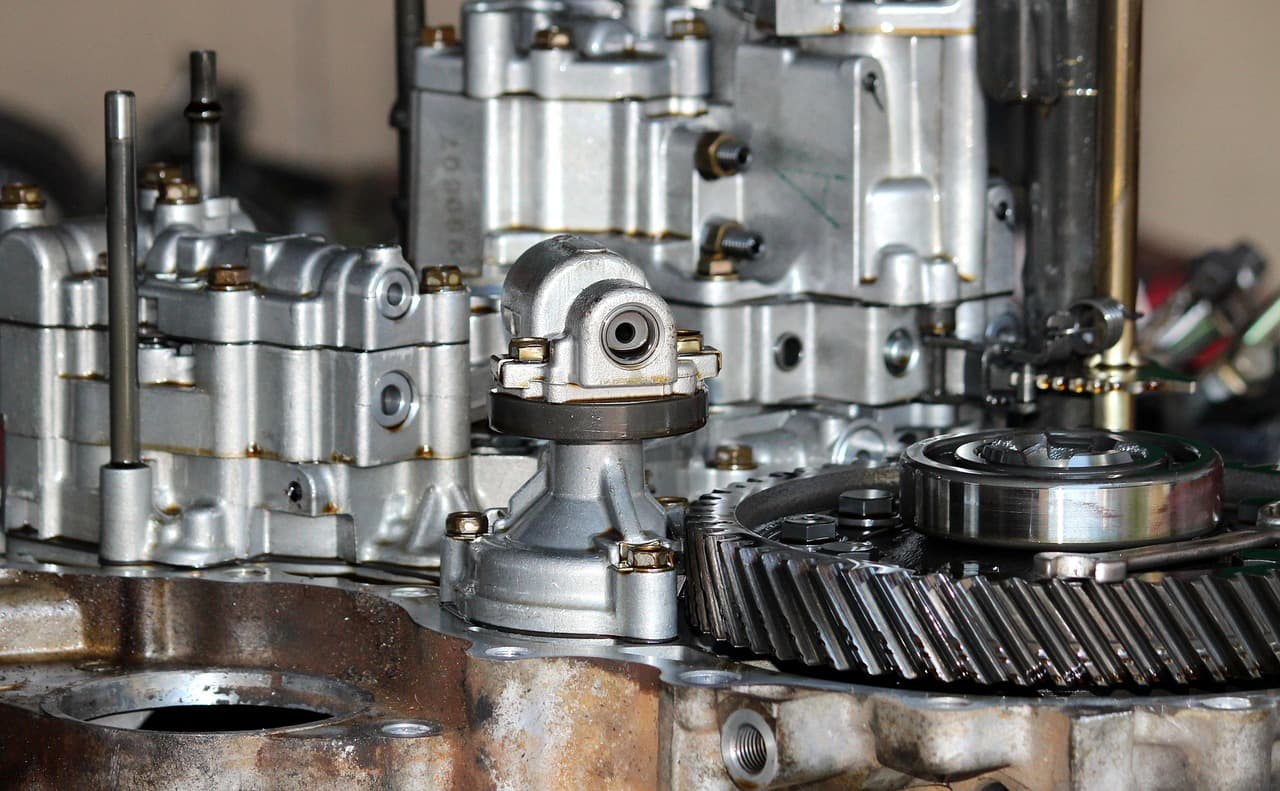 A gearbox opened up on the bench, its gears showing
